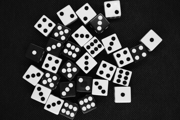 Close up of white and black dice isolated on a black background