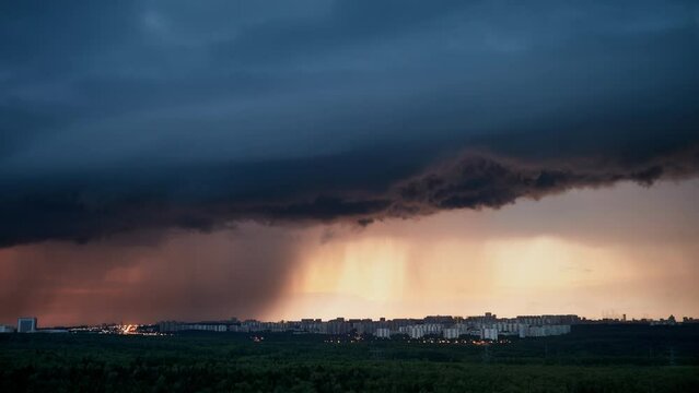 The dramatic cloudscape during the evening sky foretells rain and a lightning storm approaching, time lapse