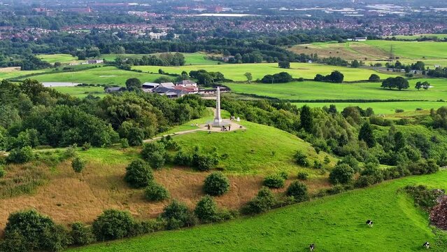 Tandle Hill and the green field with live stock grazing around. 