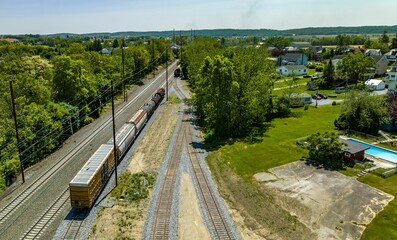 Aerial View of a Steam Locomotive Moving Freight Cars Around in a Freight Yard