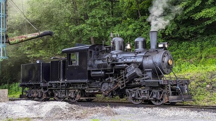 Side View of a Climax Antique Steam Locomotive Warming Up for a Days Work