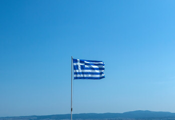 greek flag waving in the sun and wind