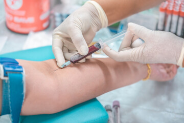 Close up hand of nurse, taking blood sample from a patient in the hospital