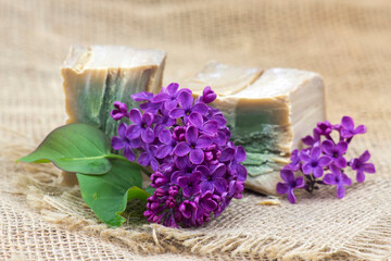 Obraz na płótnie Canvas bar of natural soap and lilac flowers - aromatherapy