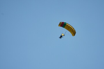 Low angle of a man parachuting in the sky at a airshow in Fehraltorf, Switzerland