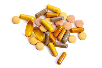 Multicolored pills and medical capsules. Isolate on white background