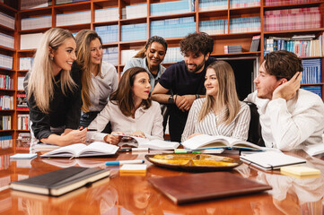 Group of students talking and smiling with their professor
