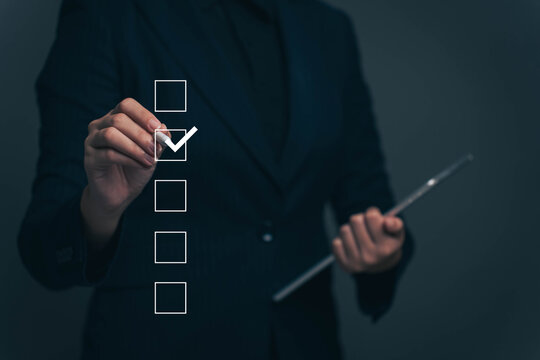 Businessman making correct mark for document approval, taking assessment, questionnaire, evaluation, online survey.