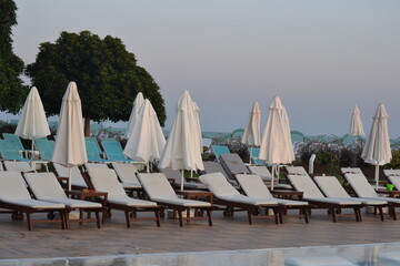 Obraz na płótnie Canvas Beach chairs next to each other right by the pool