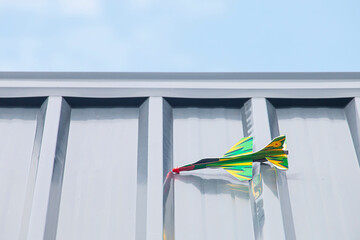 Colorful children's toy plane stuck on the roof.