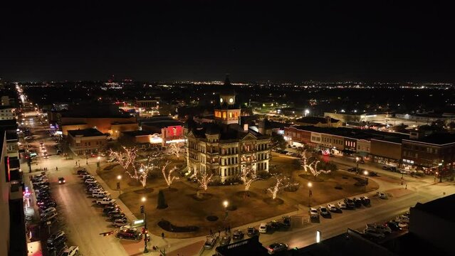 Aerial view of Denton Texas courthouse illuminated by lights at night
