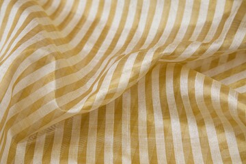 Close-up shot of a white and yellow striped fabric material, with crisp, clean lines