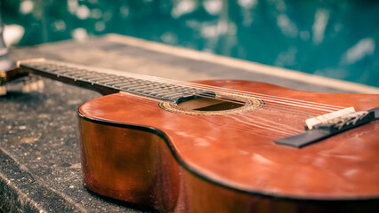 Acoustic guitar on the bench in the evening