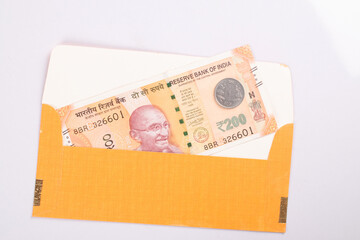 Top view of shagun envelope with indian money isolated on white background