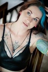 Fototapeta premium Young Caucasian female with blue hair and tattoos