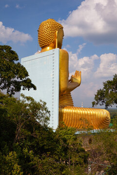 The giant golden Buddha statue sitting on the roof of the Golden Temple in Dambulla, Sri Lanka. Built in 2001 it is said to be the largest of its kind in the world.