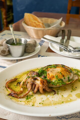 Grilled cuttlefish or choco dish in the traditional Canarian restaurant on Tenerife island, Spain.