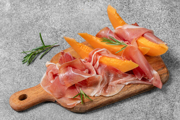 Italian ham prosciutto crudo with melon, Spanish jamon Serrano with melon
