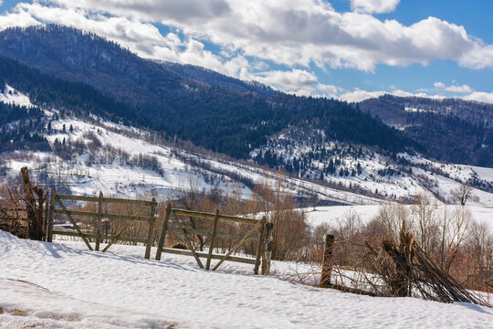 carpathian rural landscape i winter. wooden fence on the snow covered hill. bright sunny day