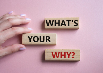 What is Your Why symbol. Concept words What is Your Why on wooden blocks. Businessman hand. Beautiful pink background. Business and What is Your Why concept. Copy space.