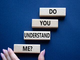 Do you understand me symbol. Concept words Do you understand me on wooden blocks. Beautiful deep blue background. Businessman hand. Business and Do you understand me concept. Copy space.