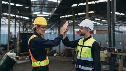 Fototapeta na wymiar Team Engineer is shaking hands. Industrial worker in the factory. Engineer is maintaining in the warehouse.