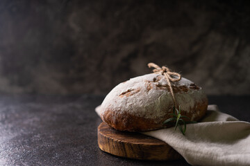 Fresh organic homemade artisan ciabatta bread on dark rustic background. sourdough bread