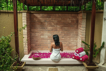 attractive young woman enjoying a bath in a spa, product photo for wellness and spa, procedure and time to relax