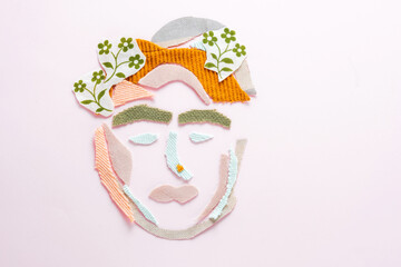 Creative concept of portrait a female face from textile waste on a pink background. Ecological and sustainable fashion. Recycling and reduce fashion waste concept. flay lay. top view