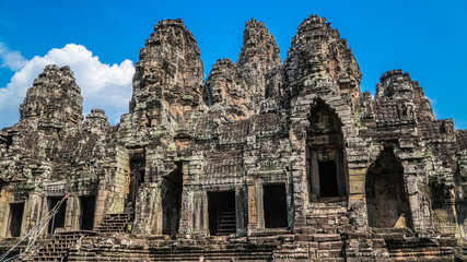 Fototapeta na wymiar Ancient ruins Thom Bayon temple - famous Cambodian landmark, Angkor Wat complex of temples. Siem Reap, Cambodia.