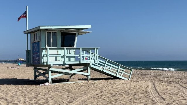 Lifeguard tower along a pacific coastline public beach with blue skies and copy space