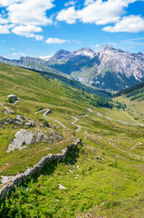 Fototapeta na wymiar Landscape panoramic view of Splugen mountain pass in Switzerland and its alpine road with tight serpentines as well as the old road.