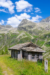 Fototapeta na wymiar Wooden shepherd hut at the Splugenpass - Passo Spluga mountain pass between Italy and Switzerland