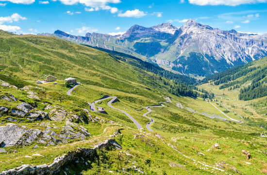 Landscape panoramic view of Splugen mountain pass in Switzerland and its alpine road with tight serpentines as well as the old road.