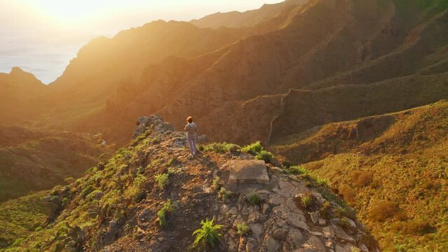 Woman watching sunset over the volcanic landscape in Masca valley, Tenerife