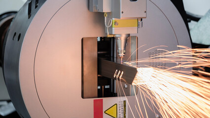 Close up scene the fiber laser cutting machine cutting  machine cut the stainless steel tube. The...
