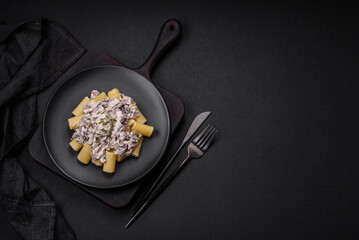 Delicious fresh pasta with champignon mushrooms in a creamy sauce