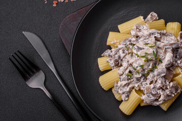 Delicious fresh pasta with champignon mushrooms in a creamy sauce