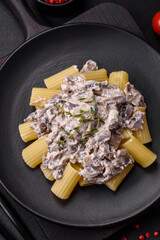 Delicious fresh pasta with champignon mushrooms in a creamy sauce