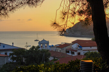 church in the lagoon in the evening. sunset. fishing boat.