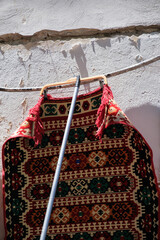 a red carpet witch is hanging on a rope in Gjirokaster Albania