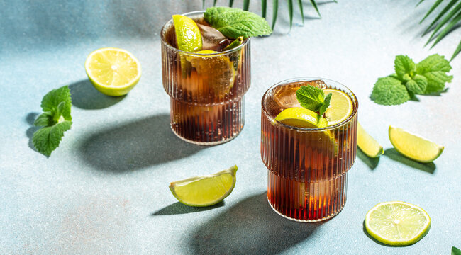 cuba libre drink with rum, cola, mint and lime in the glass. Long banner format