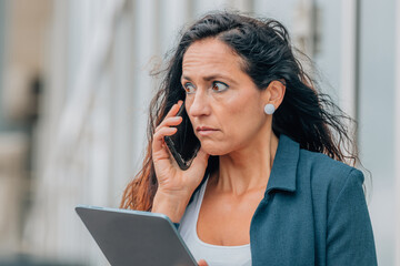 stressed business woman talking on mobile phone