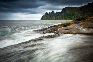Stormy rocky shoreline with powerful waves crashing