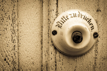 old bell button - close up - translation: please press