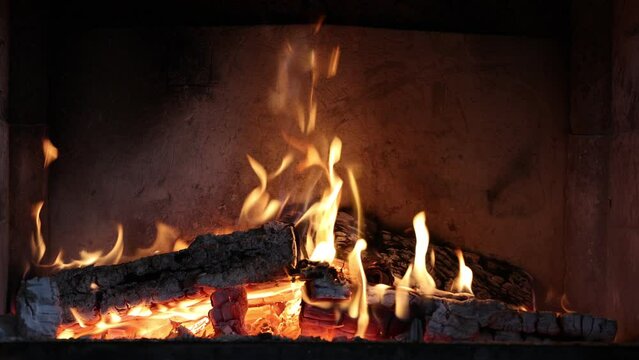 The wood burns in the fireplace