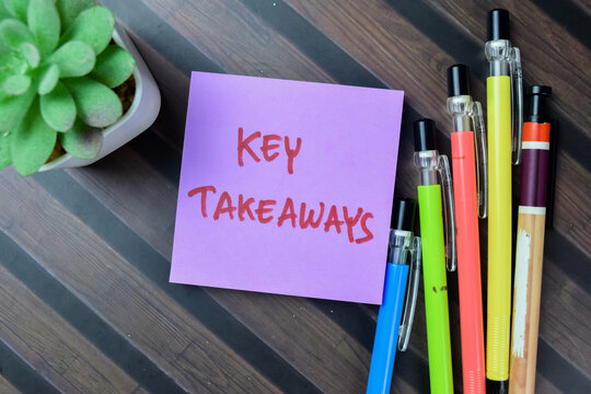Concept of Key Takeaways write on sticky notes isolated on Wooden Table.