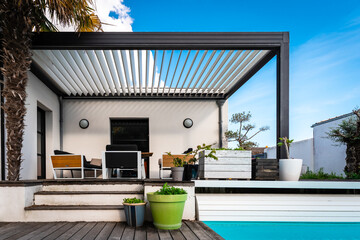 modern pergola structure in a contemporary house surrounded by a garden and swimming pool