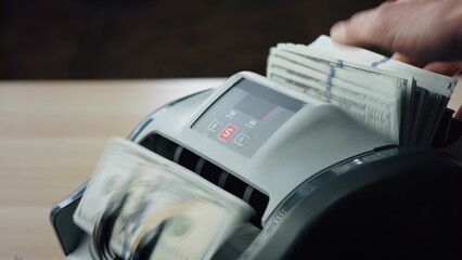 Hands putting cash counter close up. Worker calculating hundreds dollar bills.