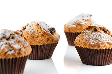Sweet muffins. Cupcakes with raisins isolated on white background. Close-up